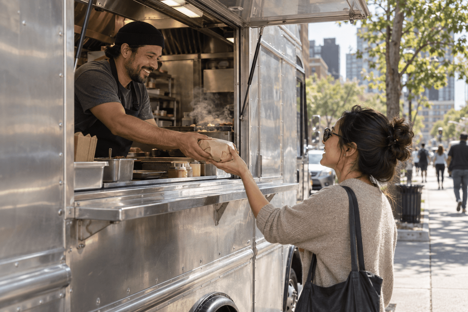 Food-truck owner handing an order to a customer at the window
